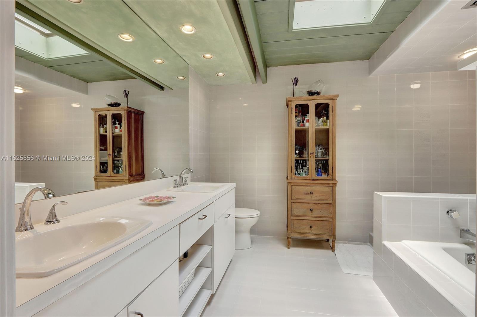 9290 Southwest 117th Terrace Miami, FL 33176 - Photo 12 of 26 a bathroom with a sink a vanity and a large mirror