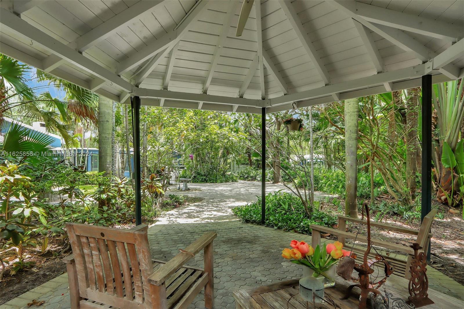 9290 Southwest 117th Terrace Miami, FL 33176 - Photo 19 of 26 a backyard of a house with wooden floor and outdoor space