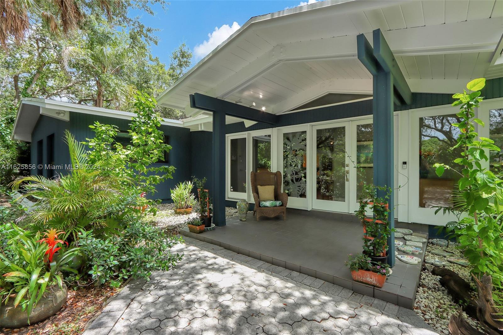 9290 Southwest 117th Terrace Miami, FL 33176 - Photo 2 of 26 a view of a house with backyard sitting area and garden