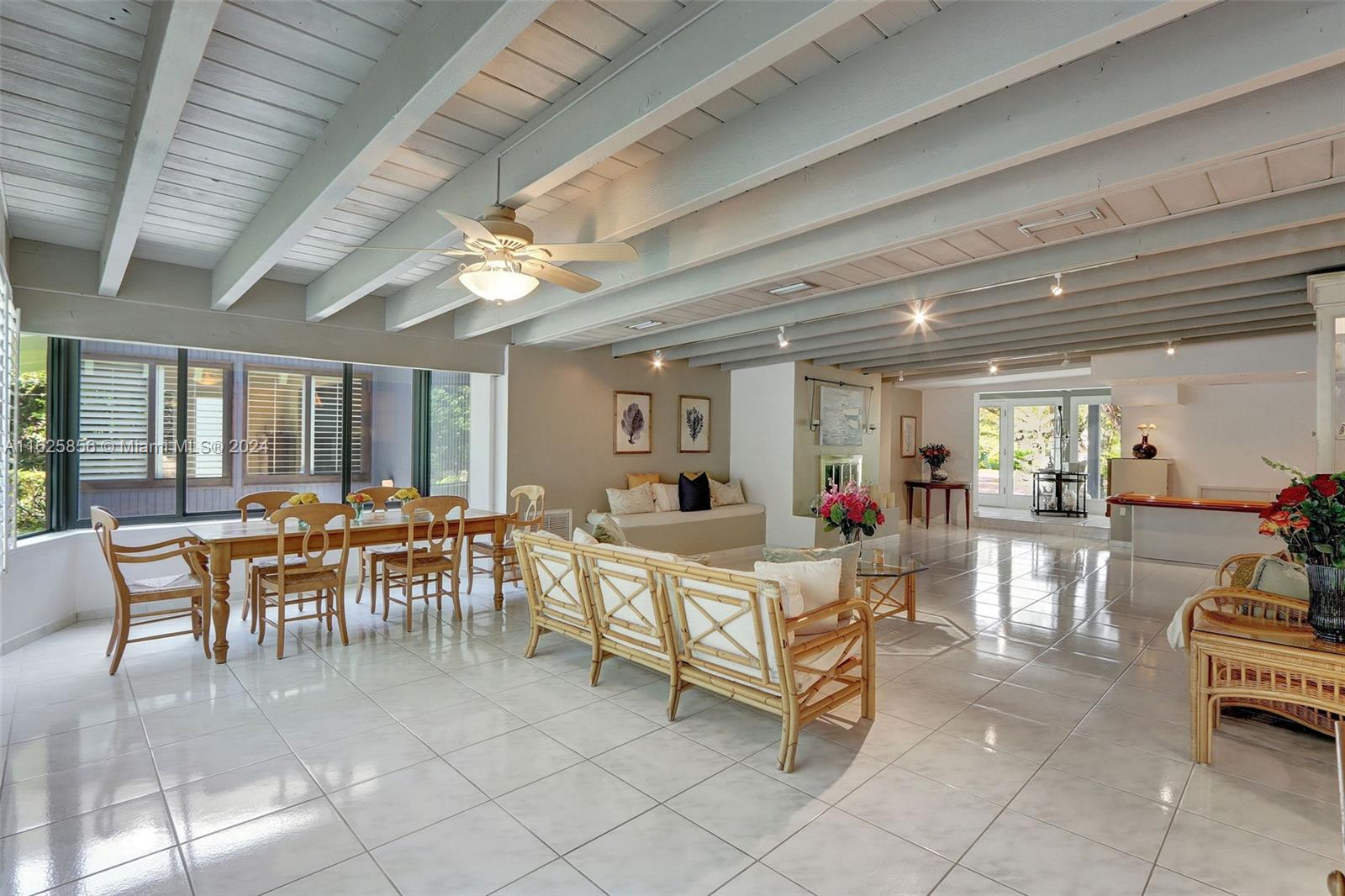 9290 Southwest 117th Terrace Miami, FL 33176 - Photo 4 of 26 a living room with furniture a dining table and a chandelier