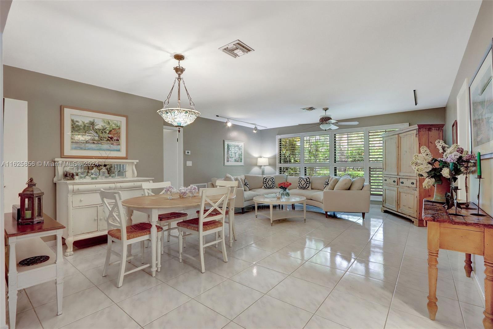 9290 Southwest 117th Terrace Miami, FL 33176 - Photo 6 of 26 a living room with furniture a chandelier and a large window