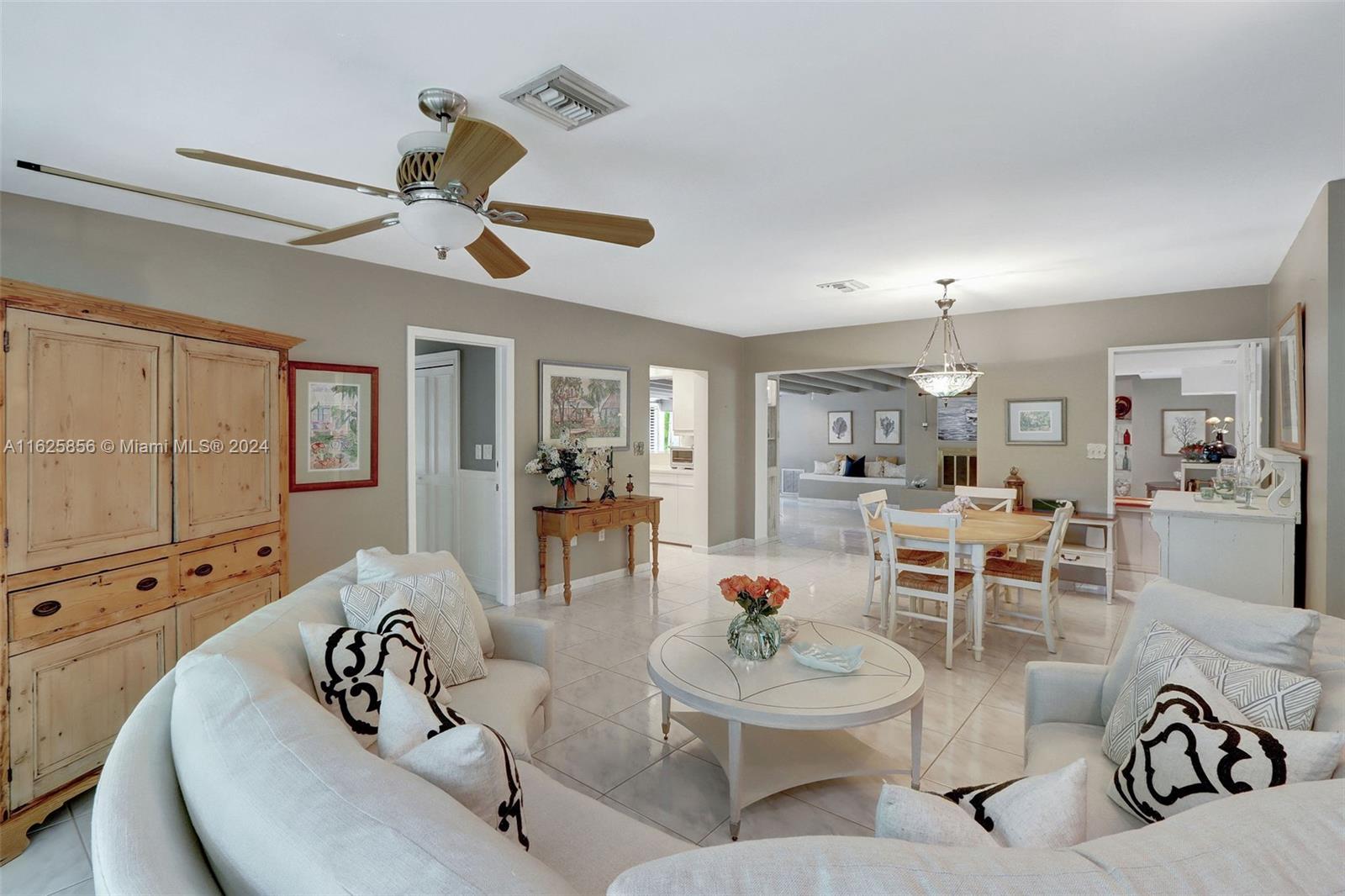 9290 Southwest 117th Terrace Miami, FL 33176 - Photo 7 of 26 a living room with furniture kitchen view and a chandelier