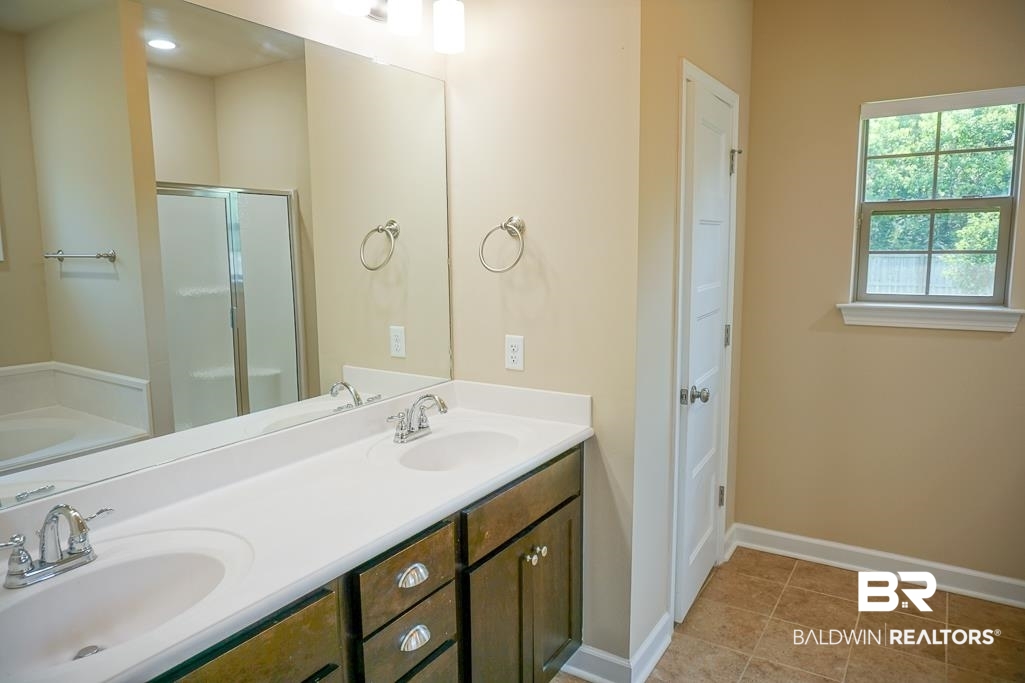 593 Begeman Road Mobile, AL 36608 - Photo 12 of 23 Bathroom with plus walk in shower, dual sinks, tile flooring, and large vanity