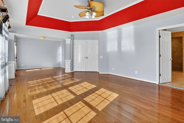 a bathroom with a double vanity sink large mirror and a bathtub