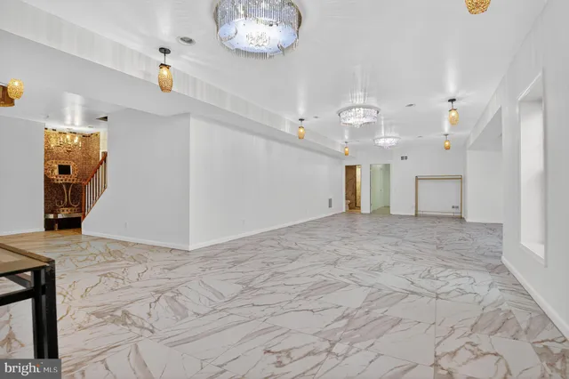 a bathroom with a granite countertop sink a toilet and shower
