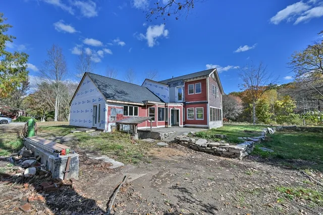 a house view with a sitting space and garden