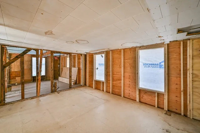 a view of a big room with wooden walls and stairs