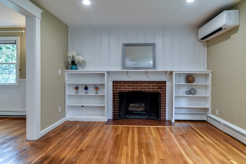48 Edgebrook Road Framingham, MA 01701 - Photo 6 of 29 a living room with a fireplace and wooden floor