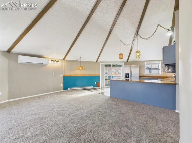 a view of a kitchen with kitchen island and a chandelier