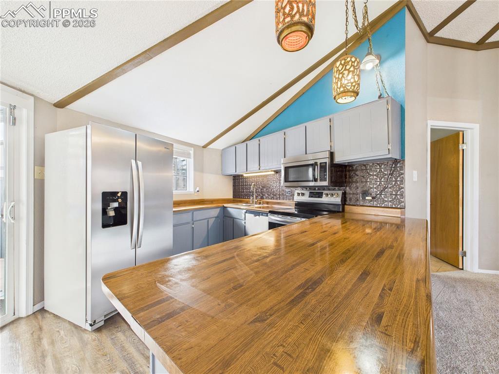 4 Bridgeport Circle Pueblo, CO 81003 - Photo 14 of 42 a kitchen with stainless steel appliances granite countertop a refrigerator a stove and a sink with granite countertops