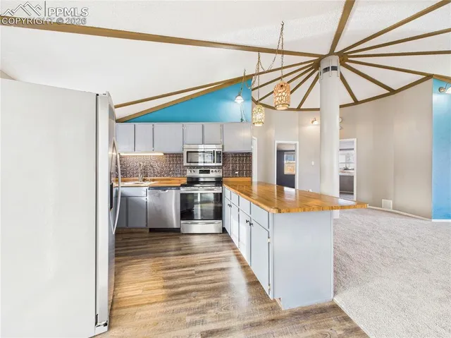 a kitchen with stainless steel appliances granite countertop a stove and a sink