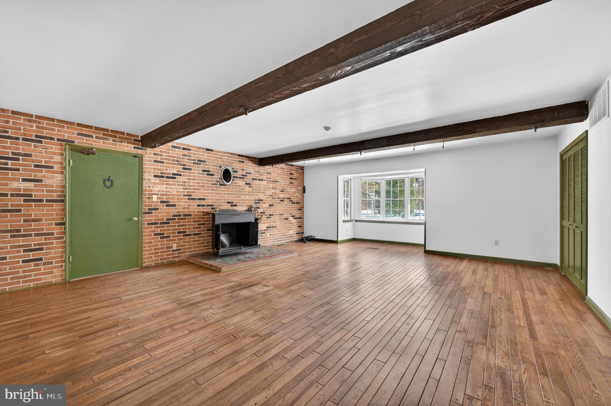425 Stokes Road Shamong, NJ 08088 - Photo 12 of 35 a view of an empty room with a fireplace and a window
