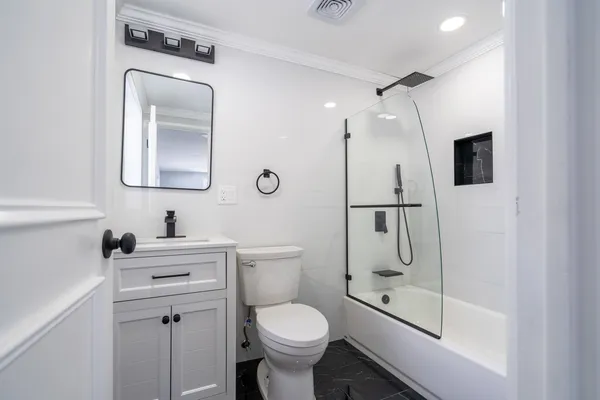 a bathroom with a toilet sink and shower