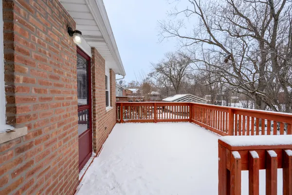 a view of balcony with wooden floor and fence