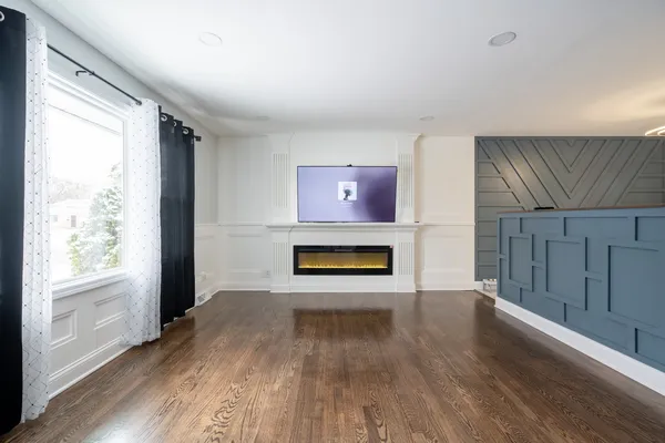 a view of a livingroom with a fireplace and window