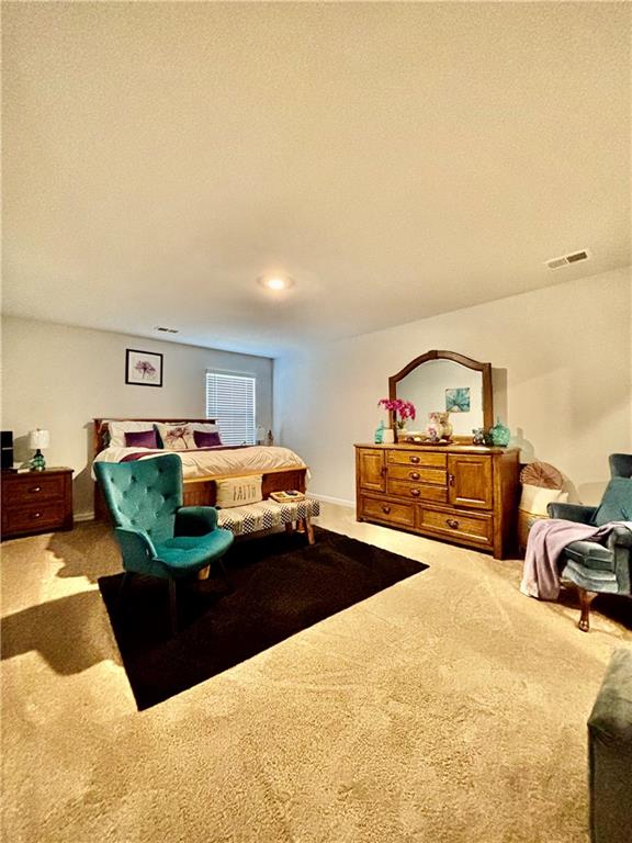 1367 Midnight Ride Drive Hampton, GA 30228 - Photo 16 of 62 a living room with furniture and a book shelf