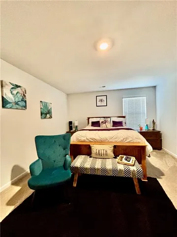 a bedroom with furniture and a window