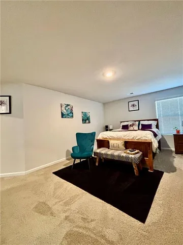 a bed room with a bed and a chair