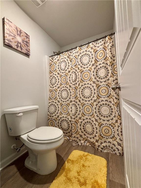 1367 Midnight Ride Drive Hampton, GA 30228 - Photo 38 of 62 a white toilet sitting next to a shower curtain