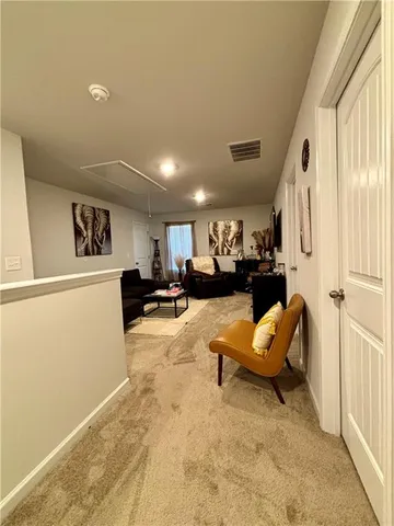 a living room with stainless steel appliances kitchen island granite countertop a sink dishwasher a dining table and chairs with wooden floor