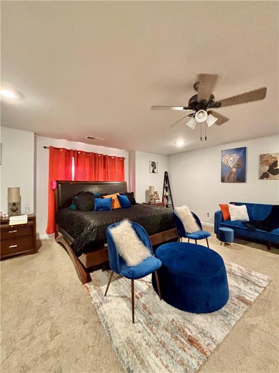 1367 Midnight Ride Drive Hampton, GA 30228 - Photo 48 of 62 a living room with furniture a rug and a ceiling fan