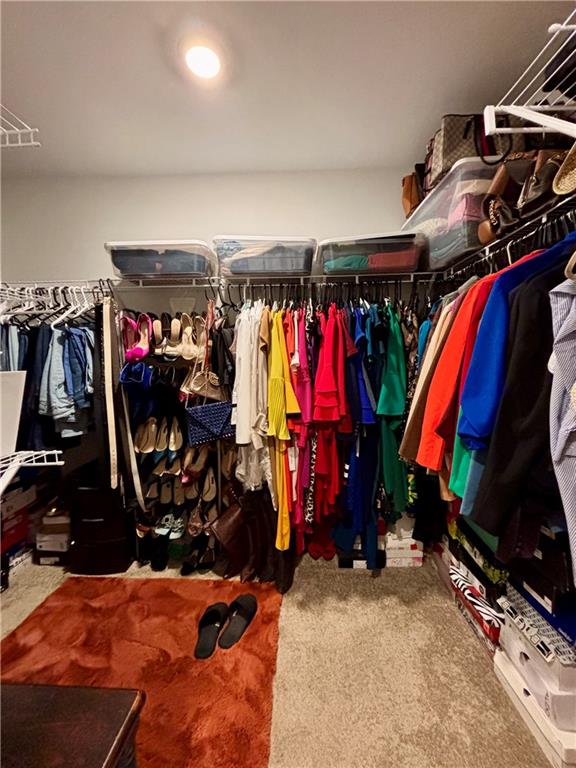 1367 Midnight Ride Drive Hampton, GA 30228 - Photo 53 of 62 a view of walk in closet with clothes