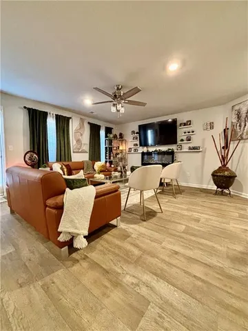 a living room with lots of furniture and kitchen view
