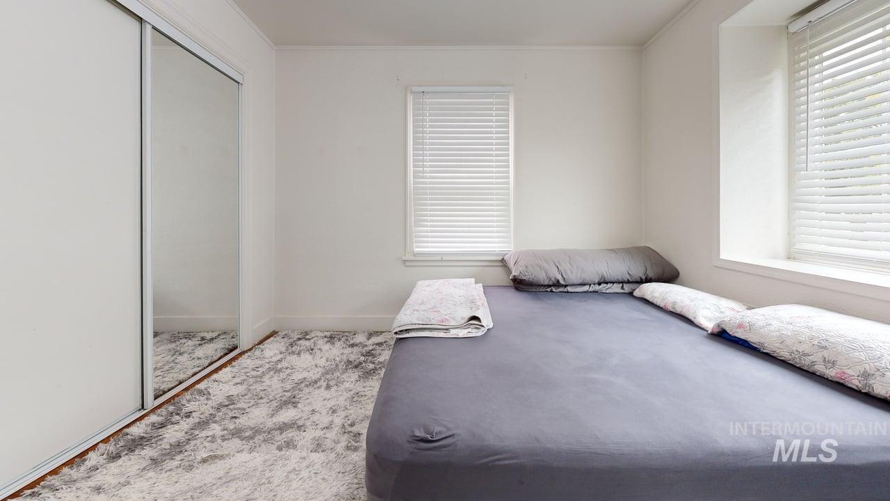 1210 10th Street Lewiston, ID 83501 - Photo 12 of 25 Bedroom with a closet, crown molding, and carpet flooring