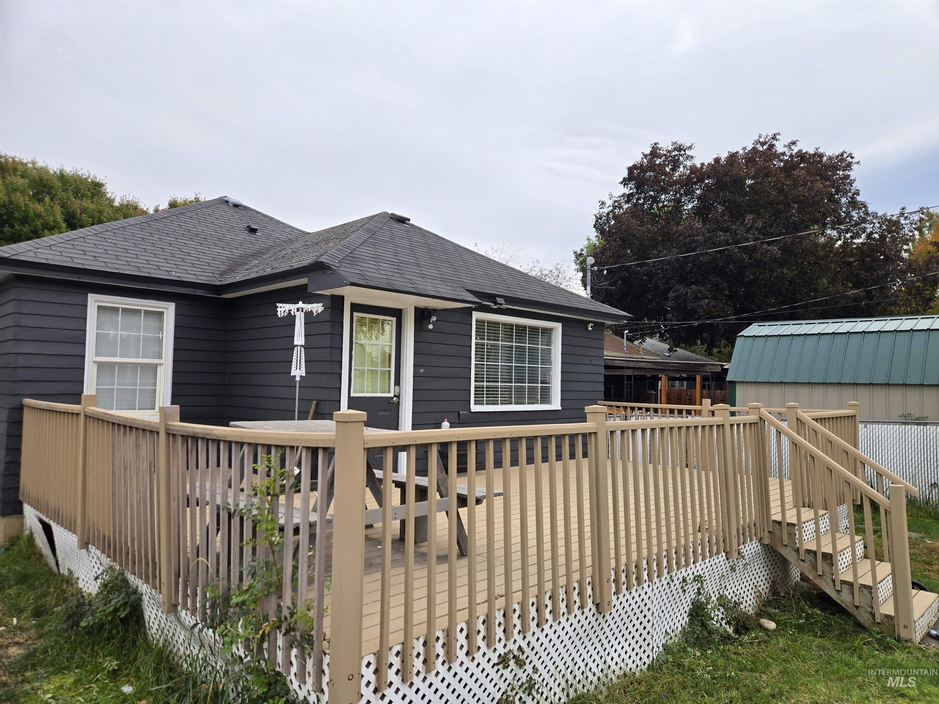 1210 10th Street Lewiston, ID 83501 - Photo 3 of 25 Back of property with a wooden deck and roof with shingles