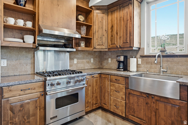 3148 Lower Saddleback Road Park City, UT 84098 - Photo 16 of 67 Gourmet kitchen featuring a stainless steel Viking range with hood, natural wood cabinetry, stone countertops, and a stainless steel farmhouse sink