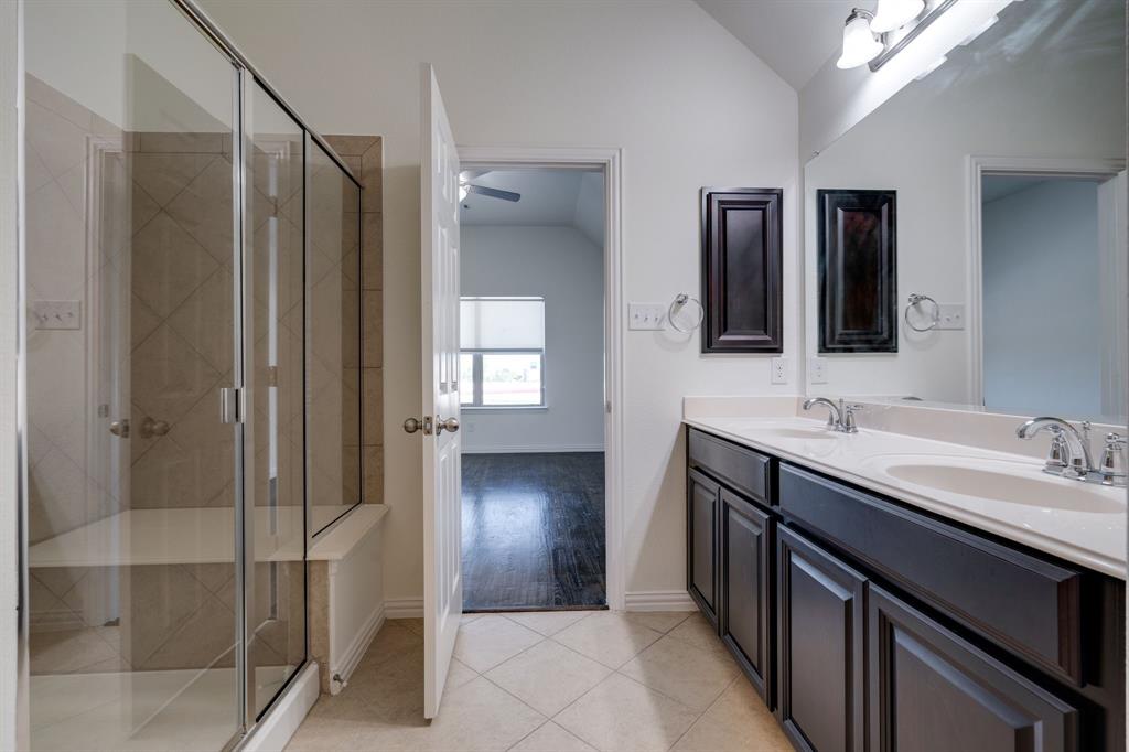 303 San Marcos Drive Irving, TX 75039 - Photo 12 of 33 a bathroom with a double vanity sink mirror and shower