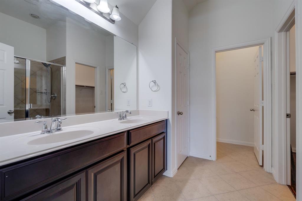 303 San Marcos Drive Irving, TX 75039 - Photo 13 of 33 a bathroom with a double vanity sink a and mirror