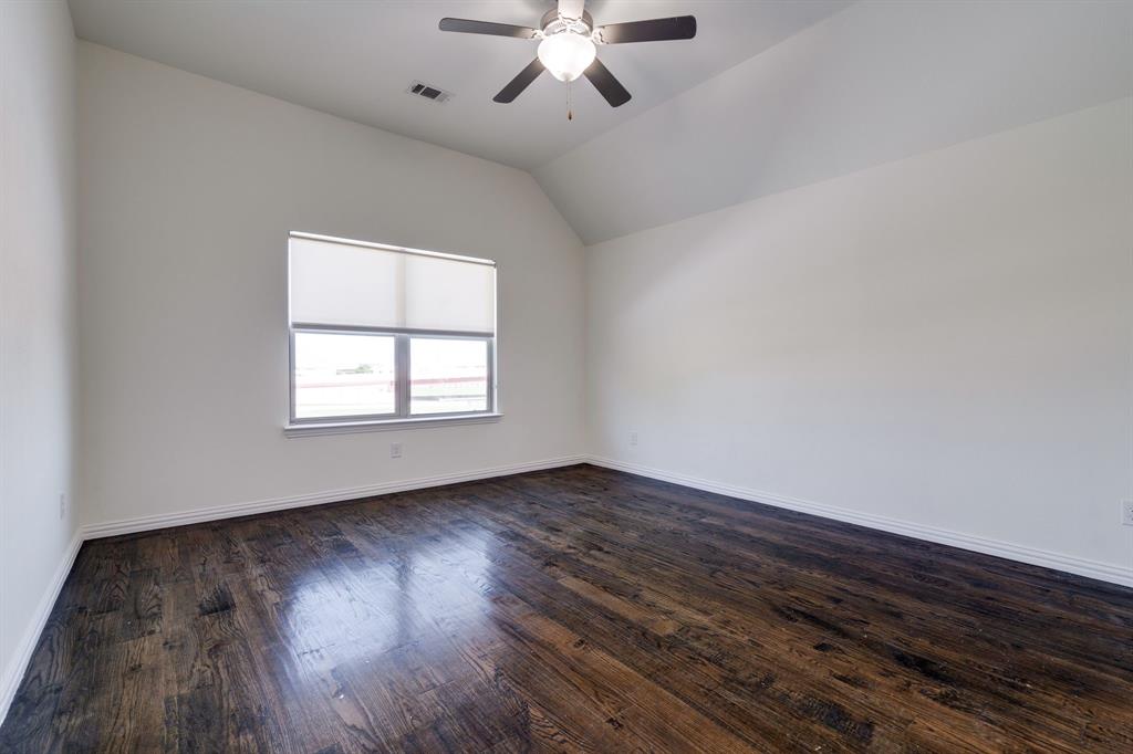 303 San Marcos Drive Irving, TX 75039 - Photo 14 of 33 an empty room with wooden floor chandelier fan and windows