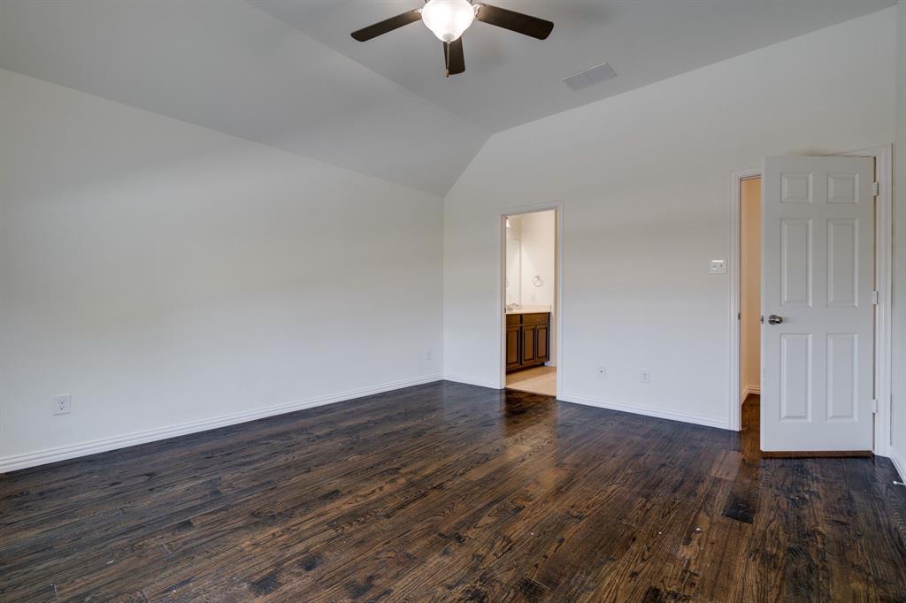 303 San Marcos Drive Irving, TX 75039 - Photo 15 of 33 an empty room with wooden floor chandelier fan and windows