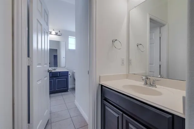 a bathroom with a sink double vanity and a mirror