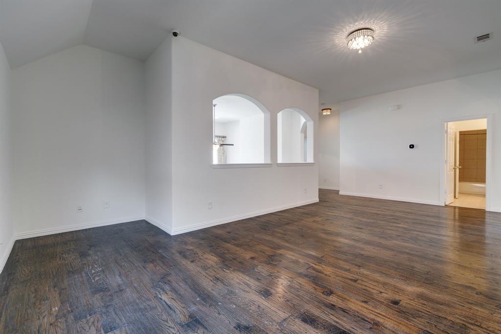 303 San Marcos Drive Irving, TX 75039 - Photo 19 of 33 a view of empty room with wooden floor and fan