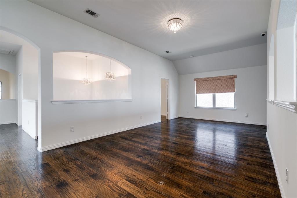 303 San Marcos Drive Irving, TX 75039 - Photo 20 of 33 an empty room with wooden floor and windows