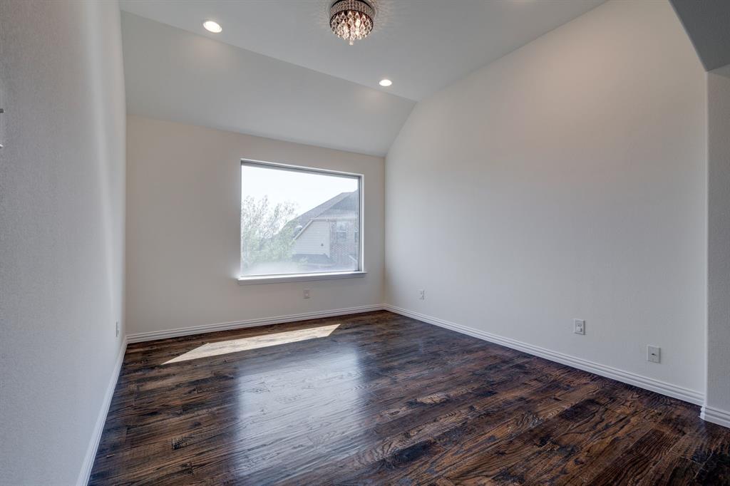 303 San Marcos Drive Irving, TX 75039 - Photo 21 of 33 an empty room with wooden floor and windows
