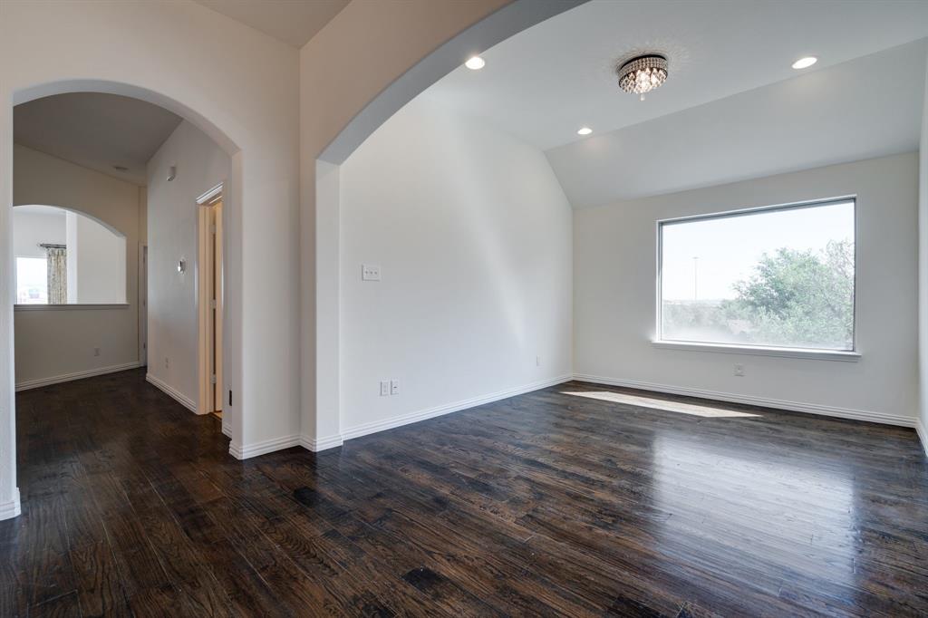 303 San Marcos Drive Irving, TX 75039 - Photo 22 of 33 an empty room with wooden floor and windows
