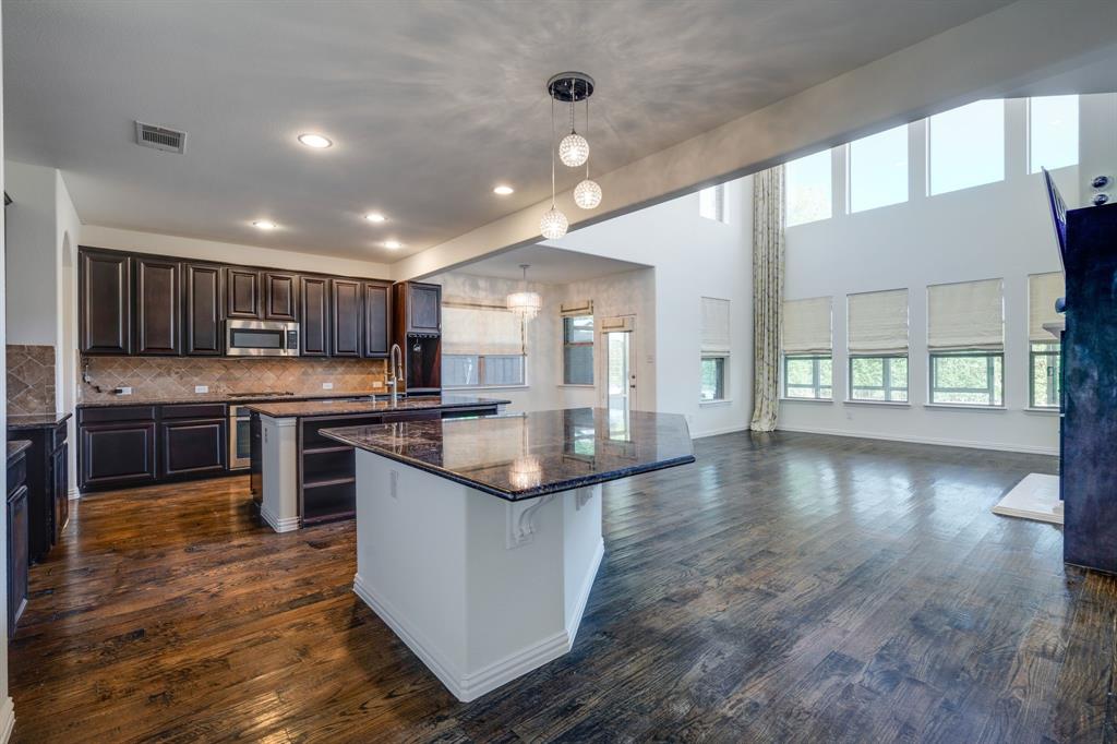 303 San Marcos Drive Irving, TX 75039 - Photo 3 of 33 a kitchen with stainless steel appliances granite countertop a stove and cabinets