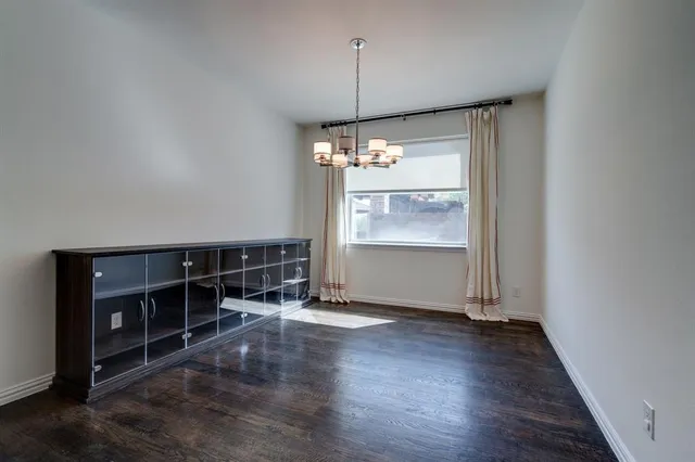 a view of a room with wooden floor and window