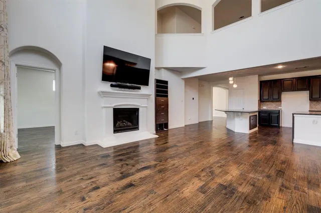 a view of a living room a flat screen tv and kitchen view