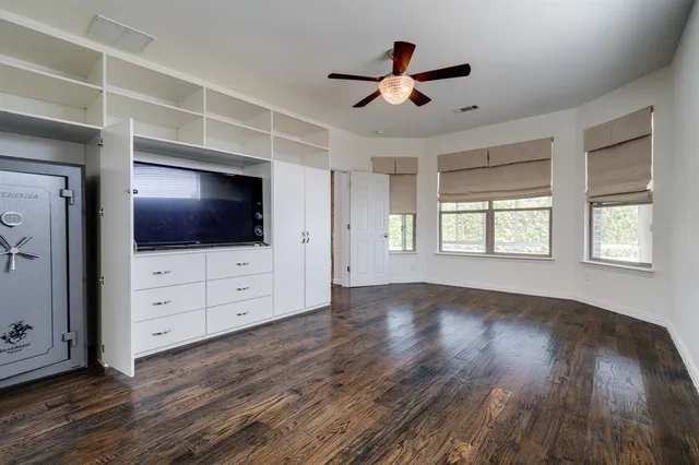 a living room with flat screen tv and a window