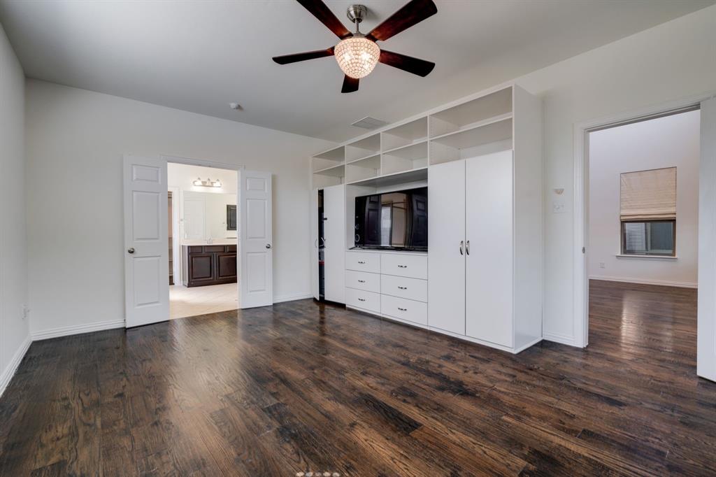 303 San Marcos Drive Irving, TX 75039 - Photo 9 of 33 a view of an empty room with wooden floor and a kitchen