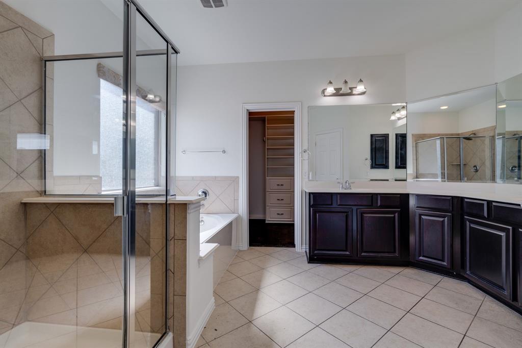 303 San Marcos Drive Irving, TX 75039 - Photo 10 of 33 a bathroom with a granite countertop double vanity sink and a mirror