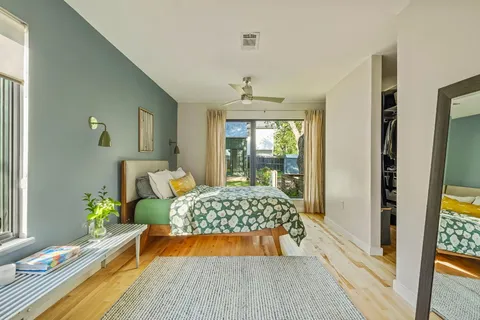 a bedroom with a bed and wooden floor