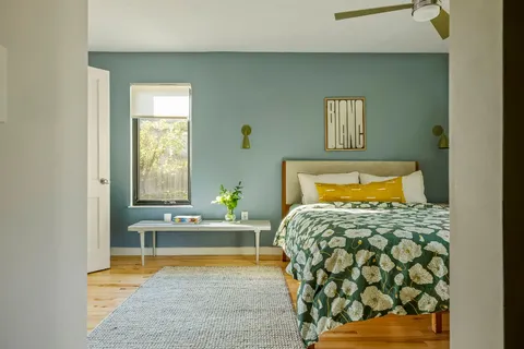 a bedroom with a bed and window