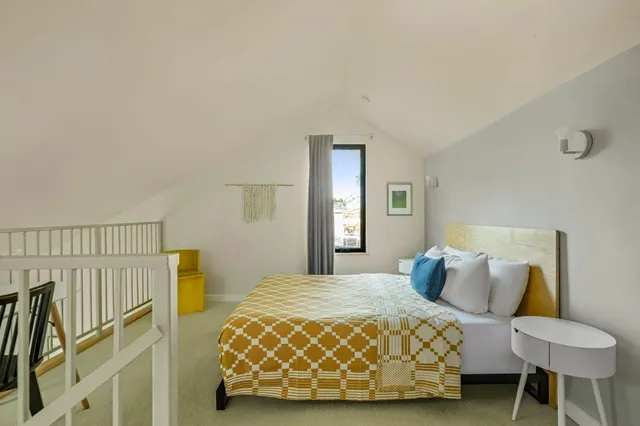 a bedroom with a bed and a chair