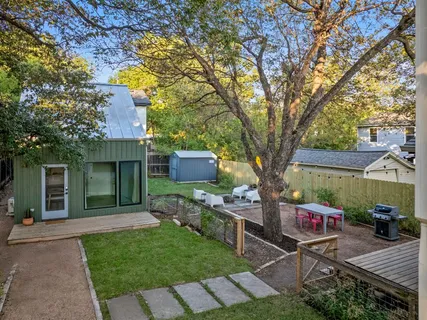 a view of a chairs and table in the backyard