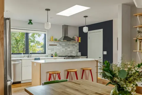 a living room with kitchen island granite countertop furniture and a large window